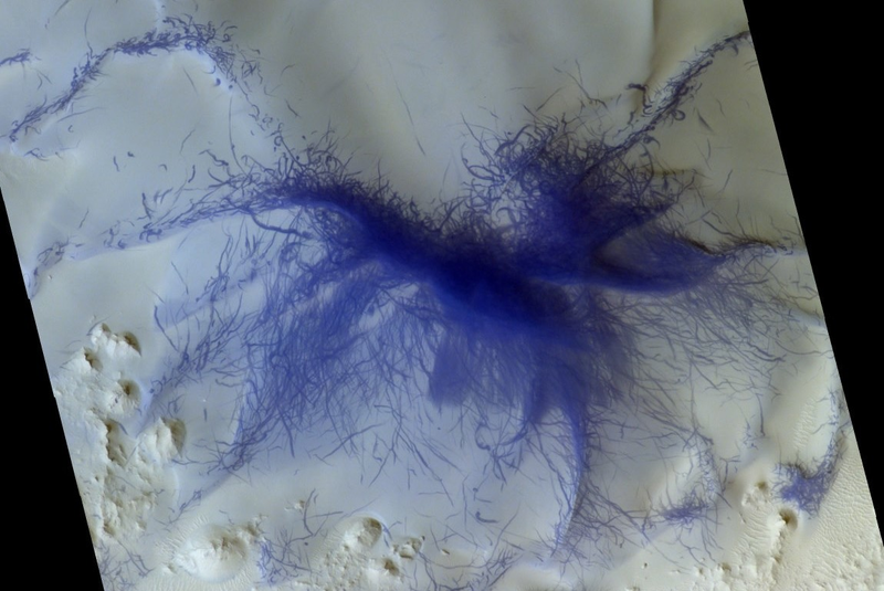 A color-composite image showing track marks left behind by the convergence of hundreds, and possibly thousands, of dust devils on Mars.